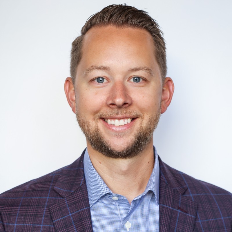 A professional headshot of Clayton Tyner